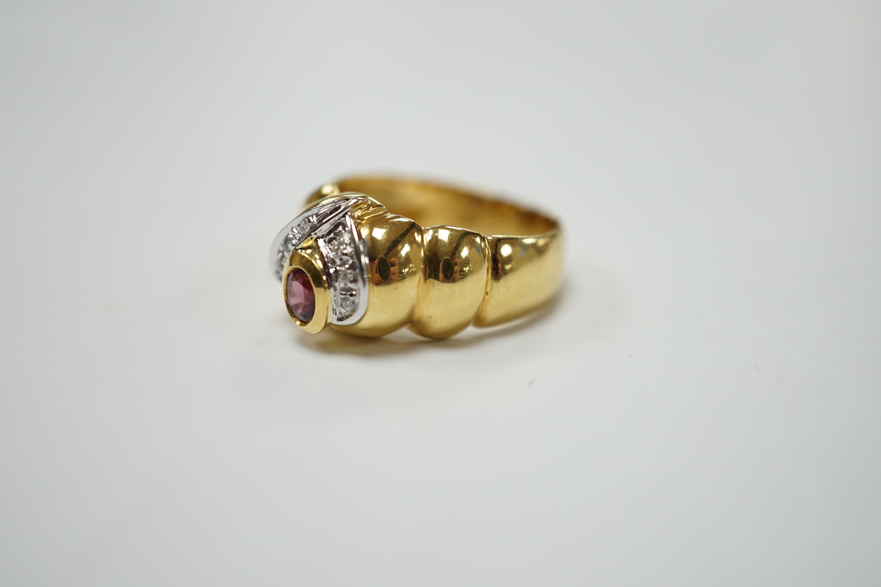 A modern 18ct gold, single stone deep pink sapphire and six stone diamond chip cluster set dress ring, size P, gross weight 8.3 grams.